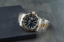 Rolex GMT-Master II 40mm Aço/Dourado Mostrador Preto Luneta Preta