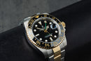 Rolex GMT-Master II 40mm Aço/Dourado Mostrador Preto Luneta Preta